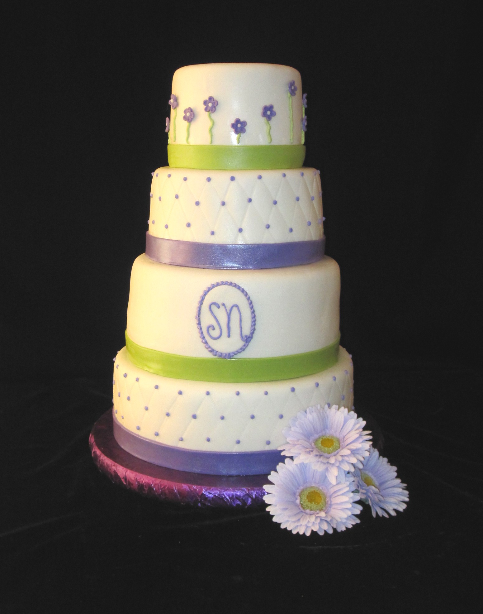 white fondant covered cake is decorated in purple and lime green ...